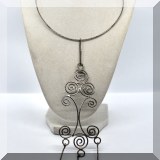 J094. Silver choker necklace with scrollwork hanging pendant. - $32 